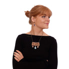 Eliza wears the Belle Epoque inspired CA VA PAS necklace with rose gold and sky drops.
