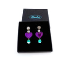 Purple heart drop earrings shown in a Wear and Resist gift box.