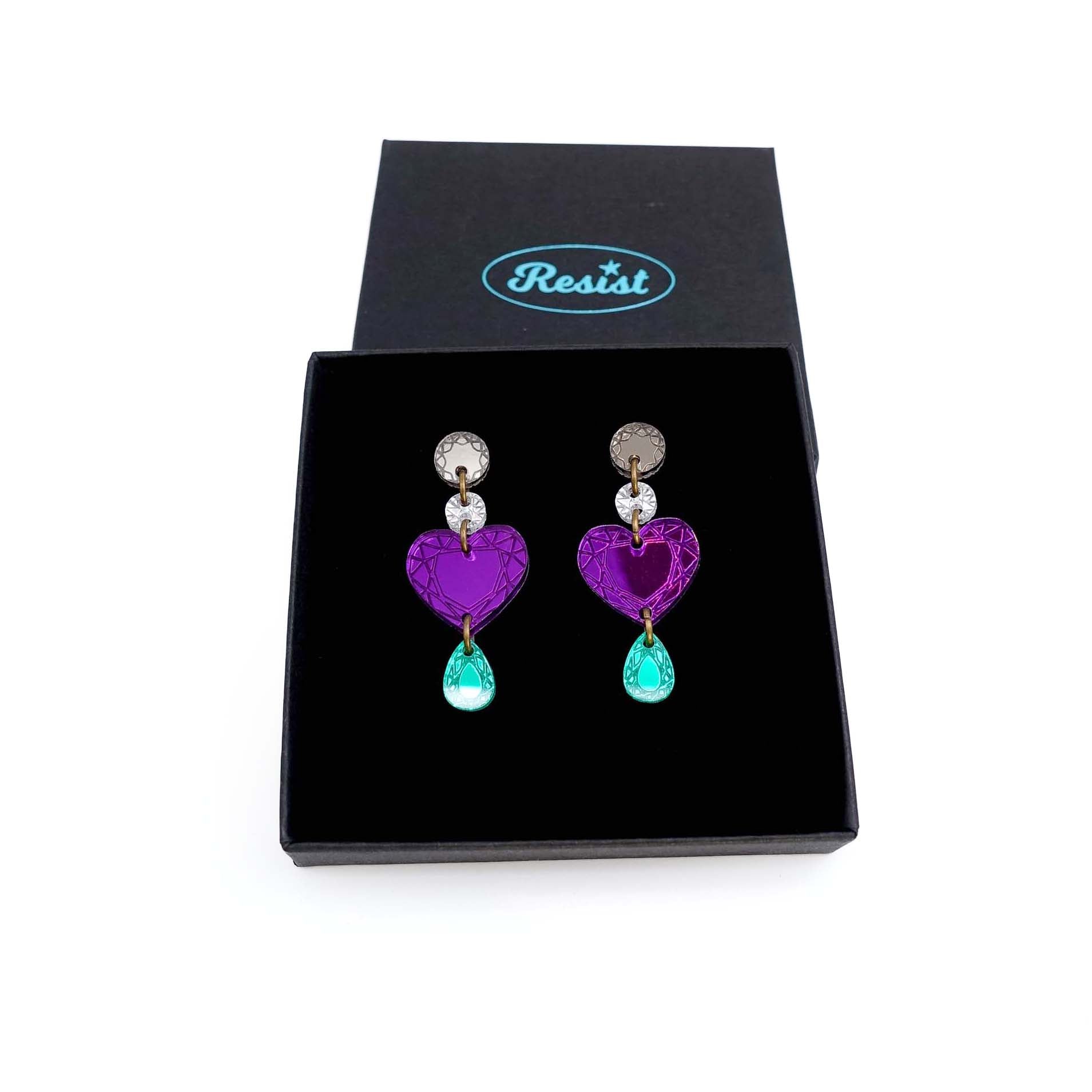 Purple heart drop earrings shown in a Wear and Resist gift box.