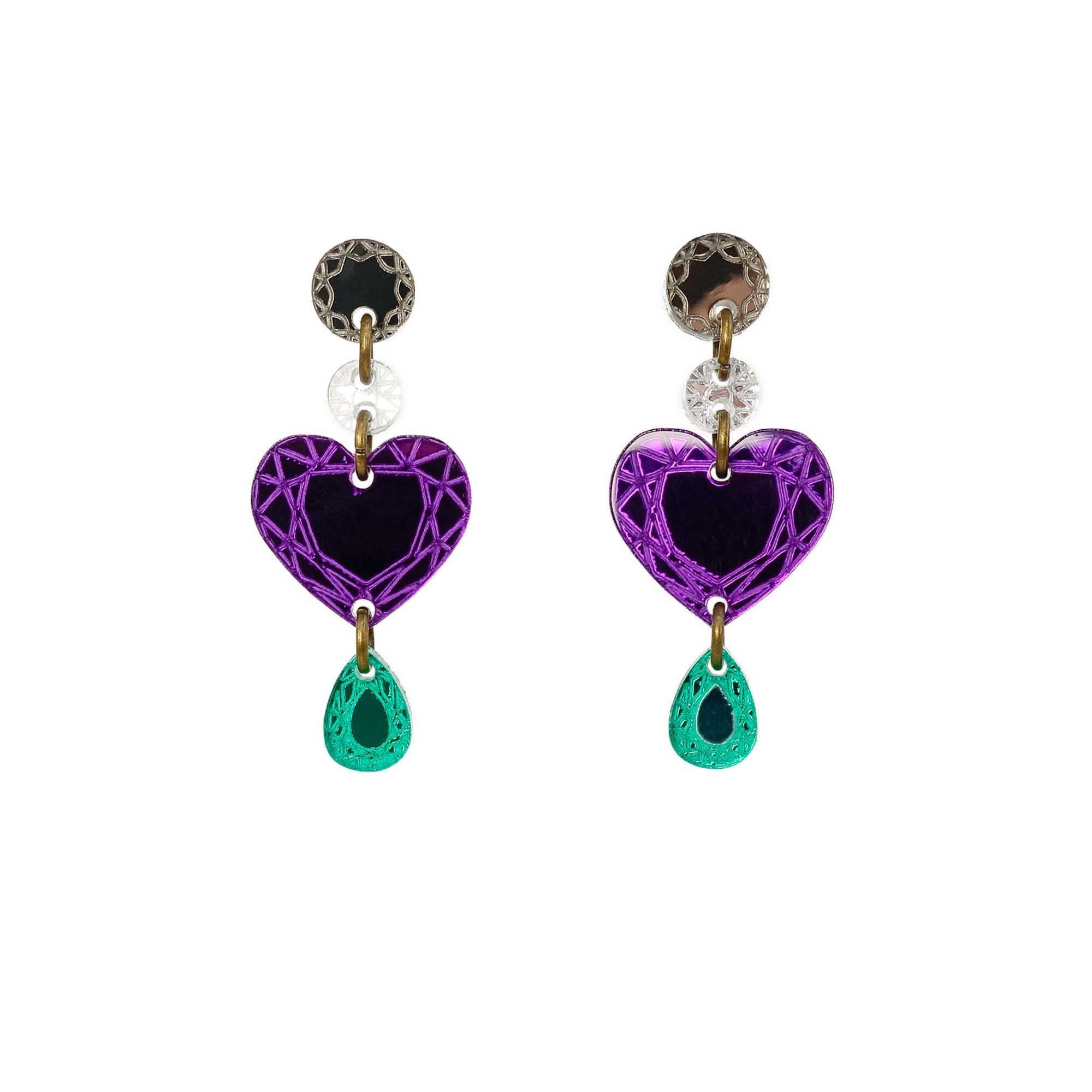 A pair of purple heart-shaped drop earrings with gold details and green gemstones at the bottom from the Suffragette Collection Women Count.