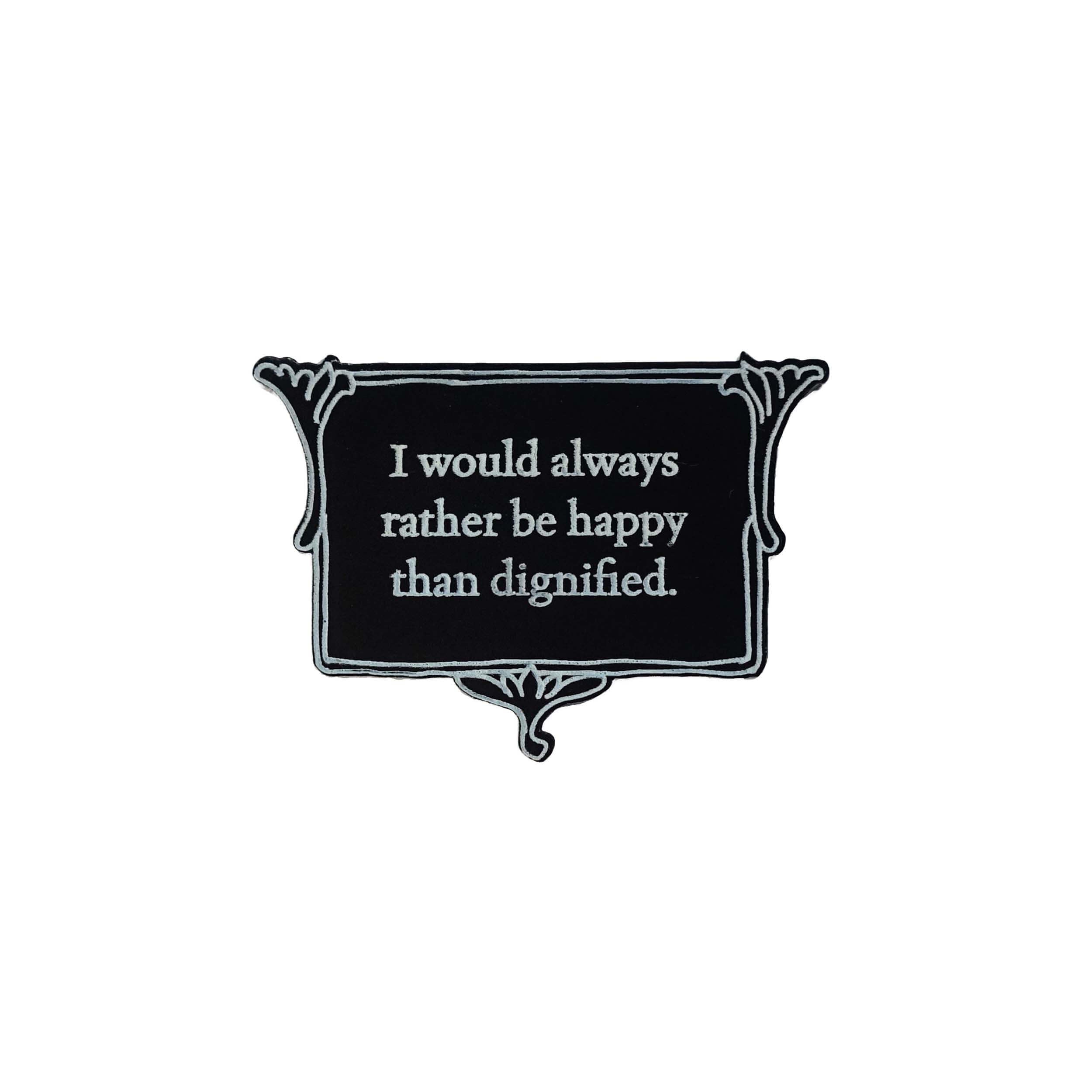 Matte black brooch etched with glow-in-the-dark pigment that says, 'I would always rather be happy than dignified.'  A quote from Charlotte Brontë's Jane Eyre from The Brontë Collection designed by Wear and Resist.