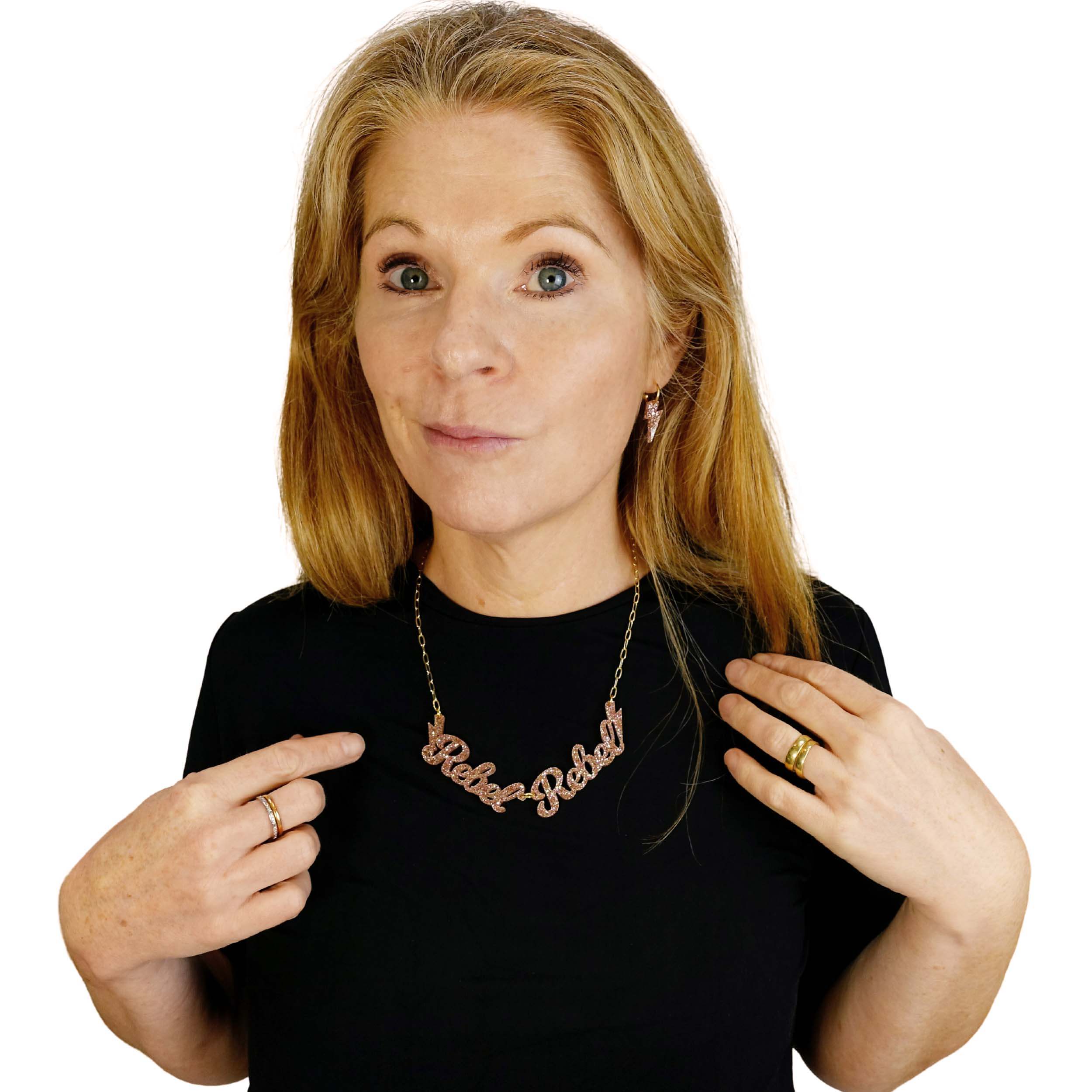 Sarah Day founder of Wear and Resist wears a champagne glitter Rebel Rebel necklace