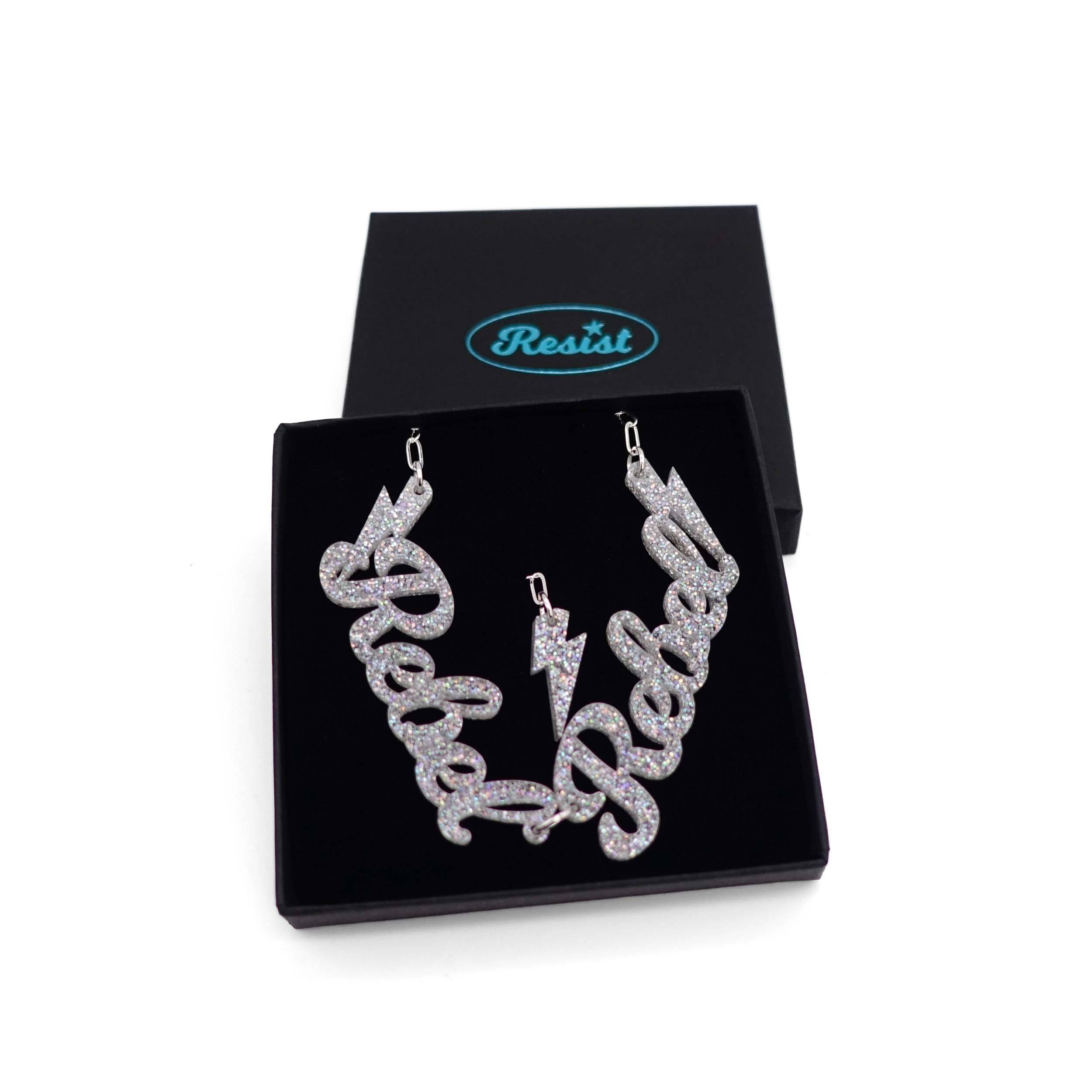 Silver glitter Rebel Rebel necklace shown in a Wear and Resist gift box.