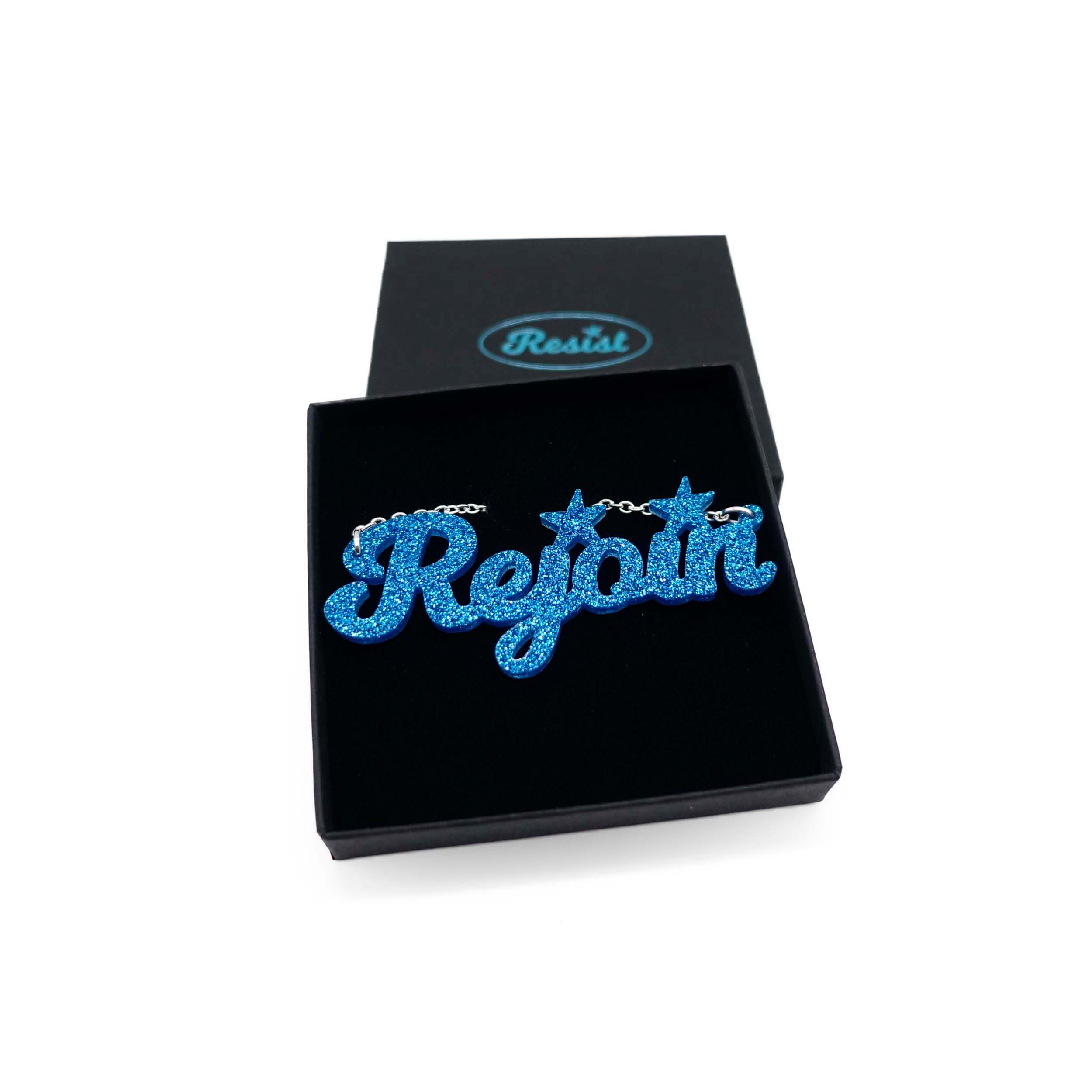 Rejoin the EU necklace in blue glitter. Shown in a Wear and Resist gift box.