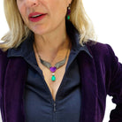 Andrea wears the Resist Persist winged heart necklace with matching Take Courage heart drop earrings.