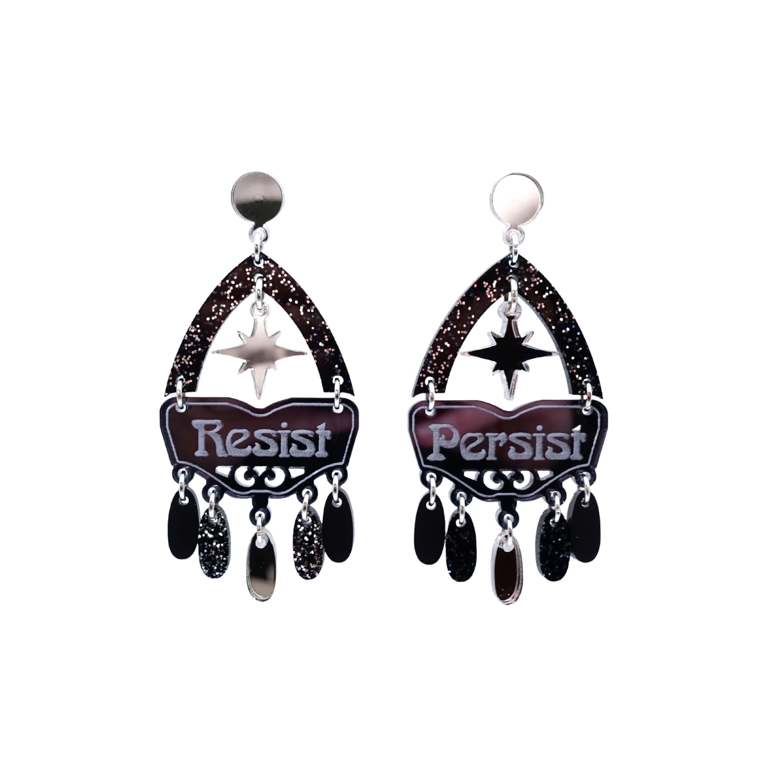 Resist and Persist statement dangly earrings in black and silver, shown cut out against a white background.