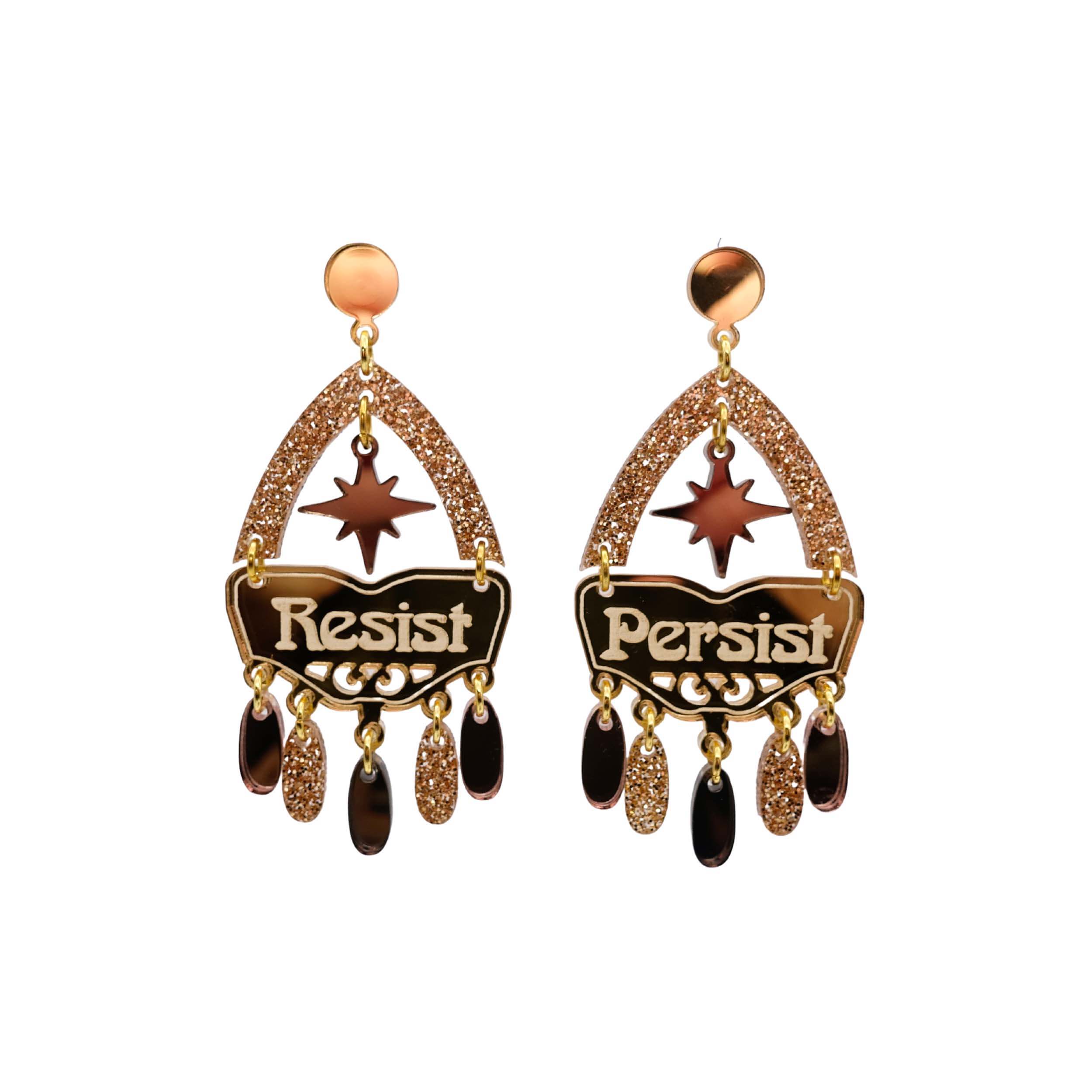Resist and Persist statement dangly earrings in gold and bronze, shown cut out against a white background.