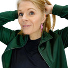 Sarah wears large Lightning Bolt hoop earrings in pink miror.