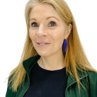 Sarah wears large Lightning Bolt hoop earrings in electric blue mirror.
