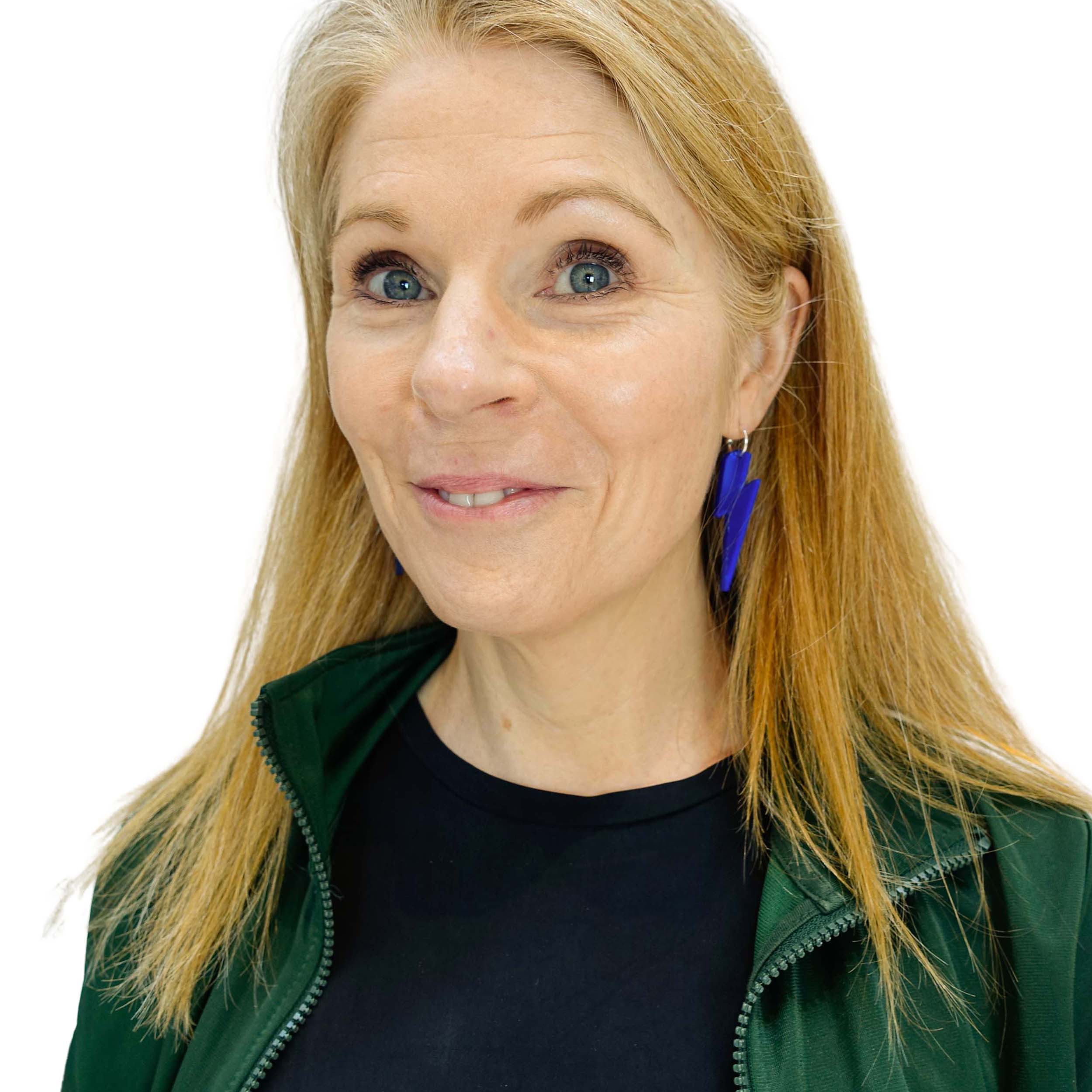 Sarah wears large Lightning Bolt hoop earrings in electric blue mirror.
