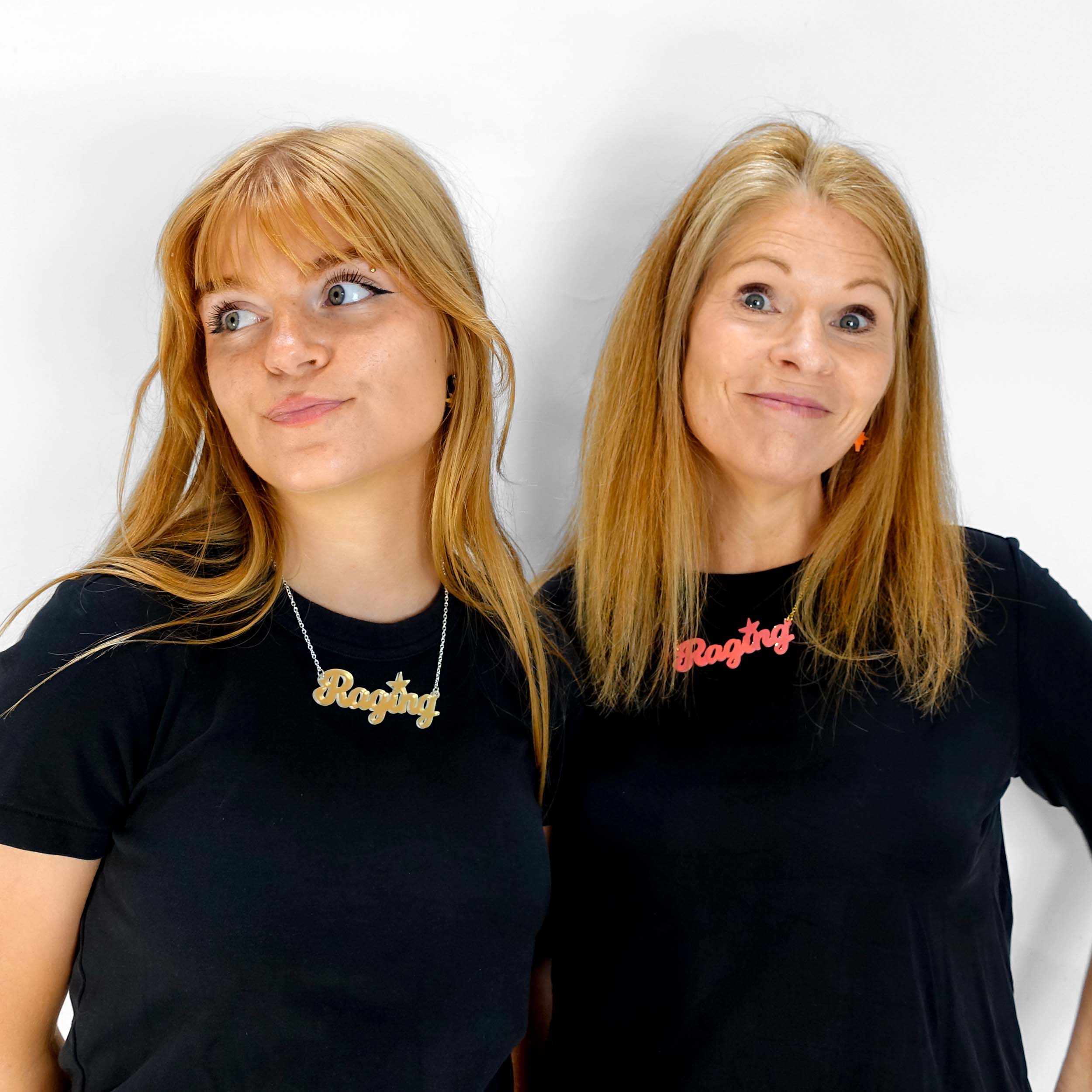 Eliza wearing a matte iridescent Raging necklace and Sarah wearing a sunset pink Raging necklace.