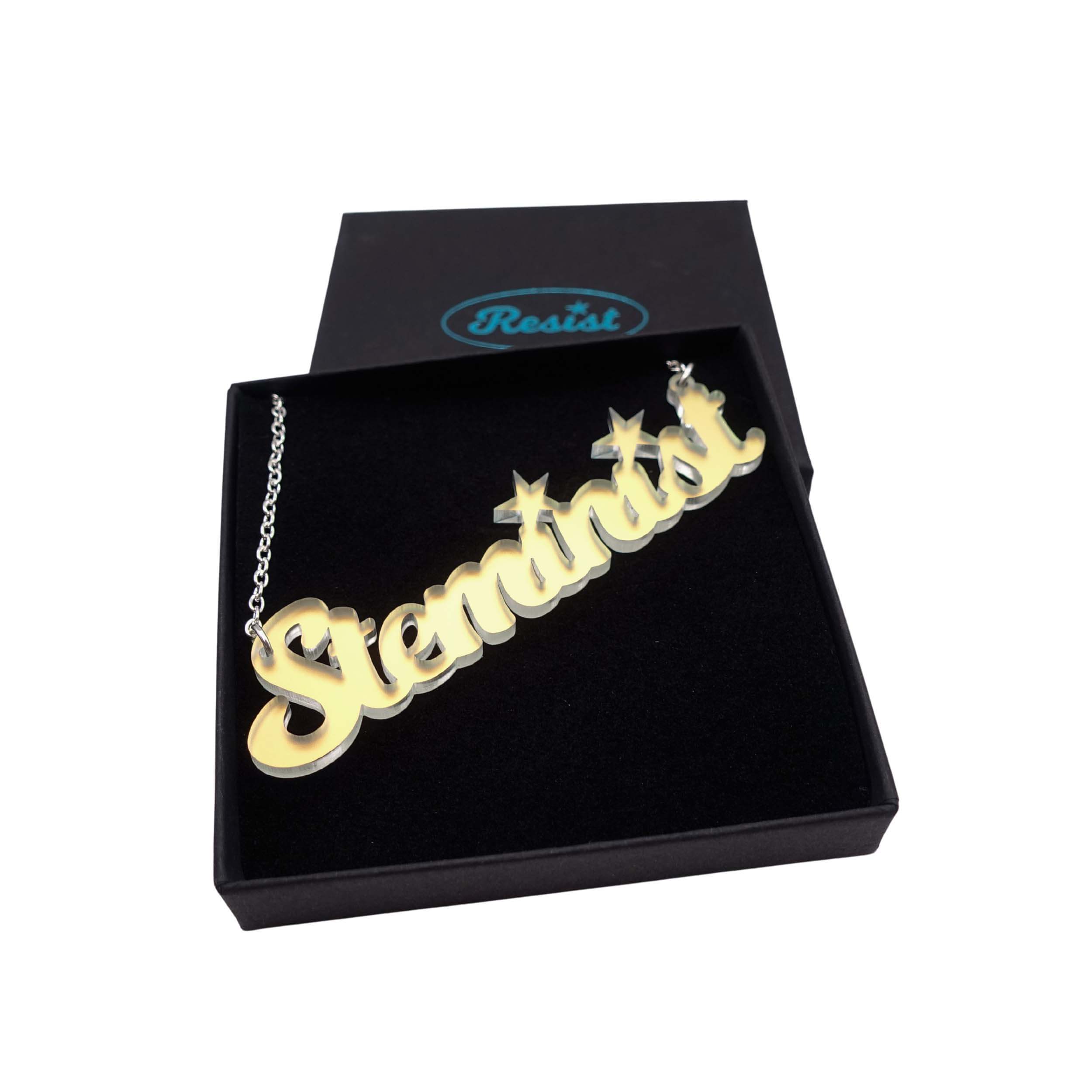 Steminist necklace for women working in STEM in matte iridescent shown in a Wear and Resist gift box.