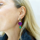 Andrea wears the Take Courage purple heart drop earrings from the Suffragette collection.