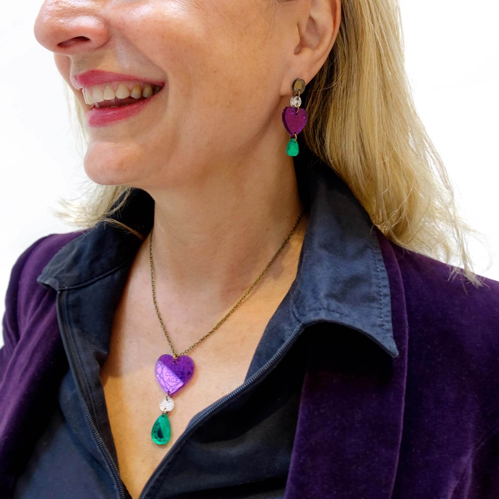 Andrea wears the Take Courage heart drop necklace with matching heart drop earrings.