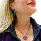 Andrea wears the Suffragette drop earrings with a Take Courage heart drop necklace.