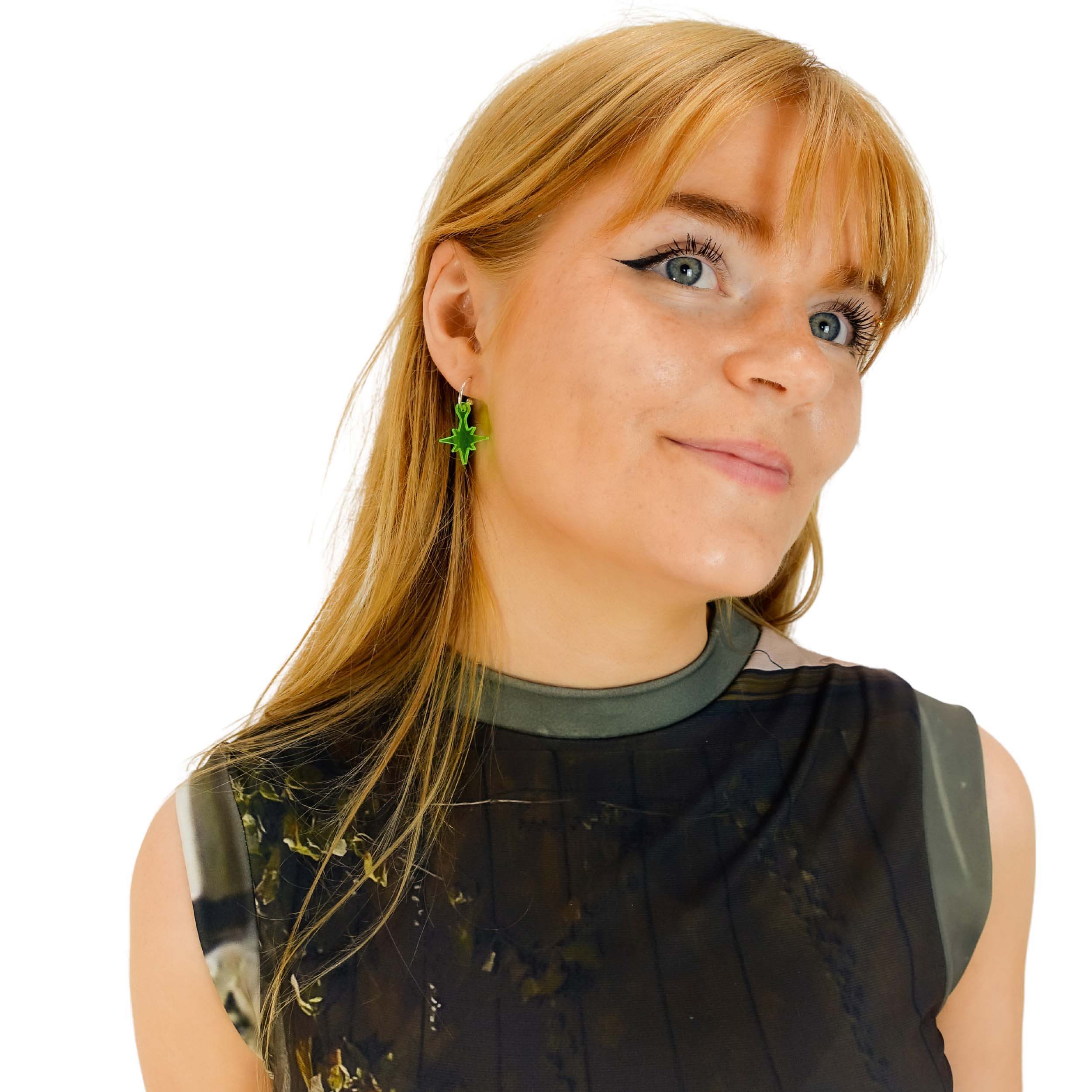 Eliza wears vintage star earrings in neon green.