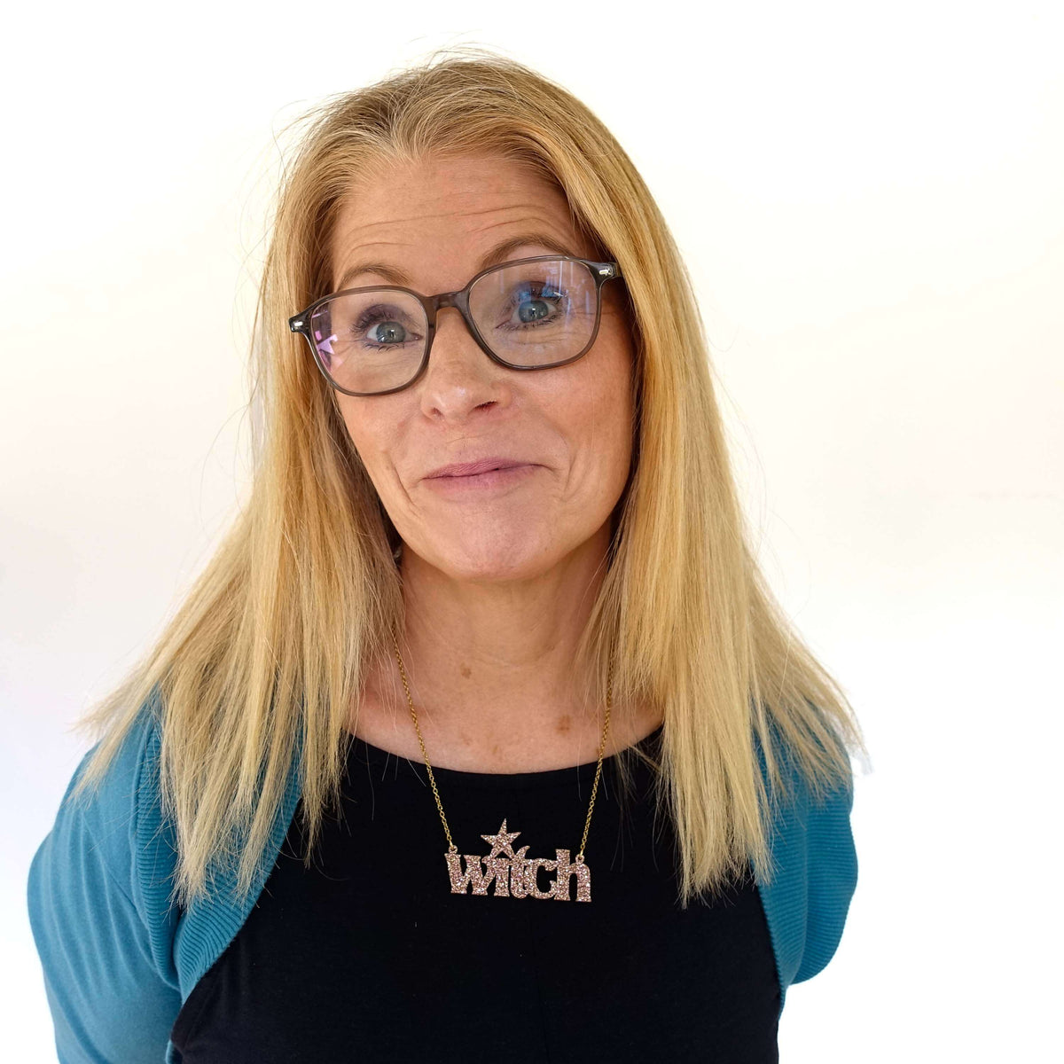 Sarah wears a large pink fizz glitter Witch necklace