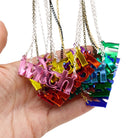A handful of Witch necklaces in all the different mirror colours.