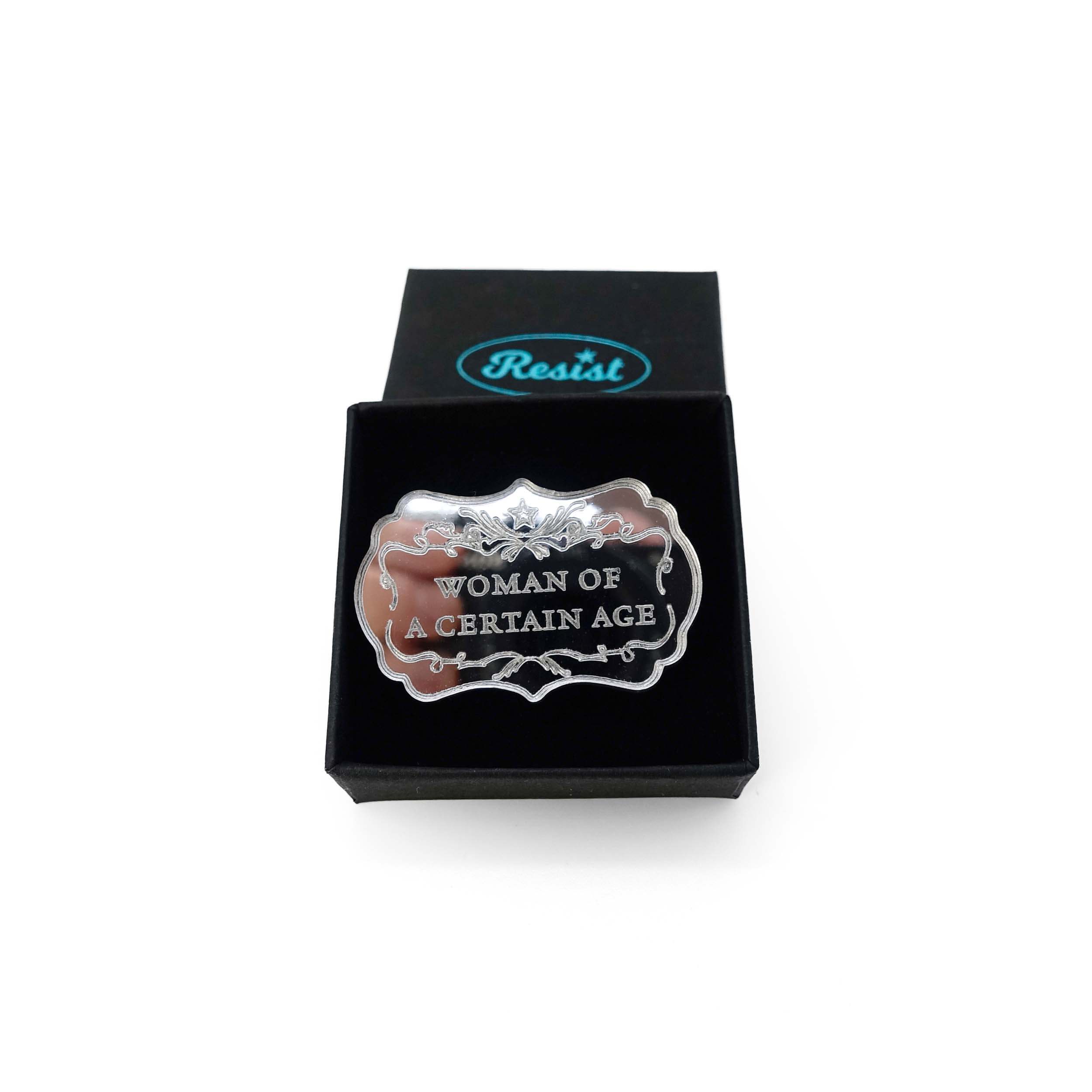 Silver mirror Woman of a Certain Age brooch shown in a small Wear and Resist gift box.