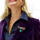 Andrea wears the Women Count brooch.