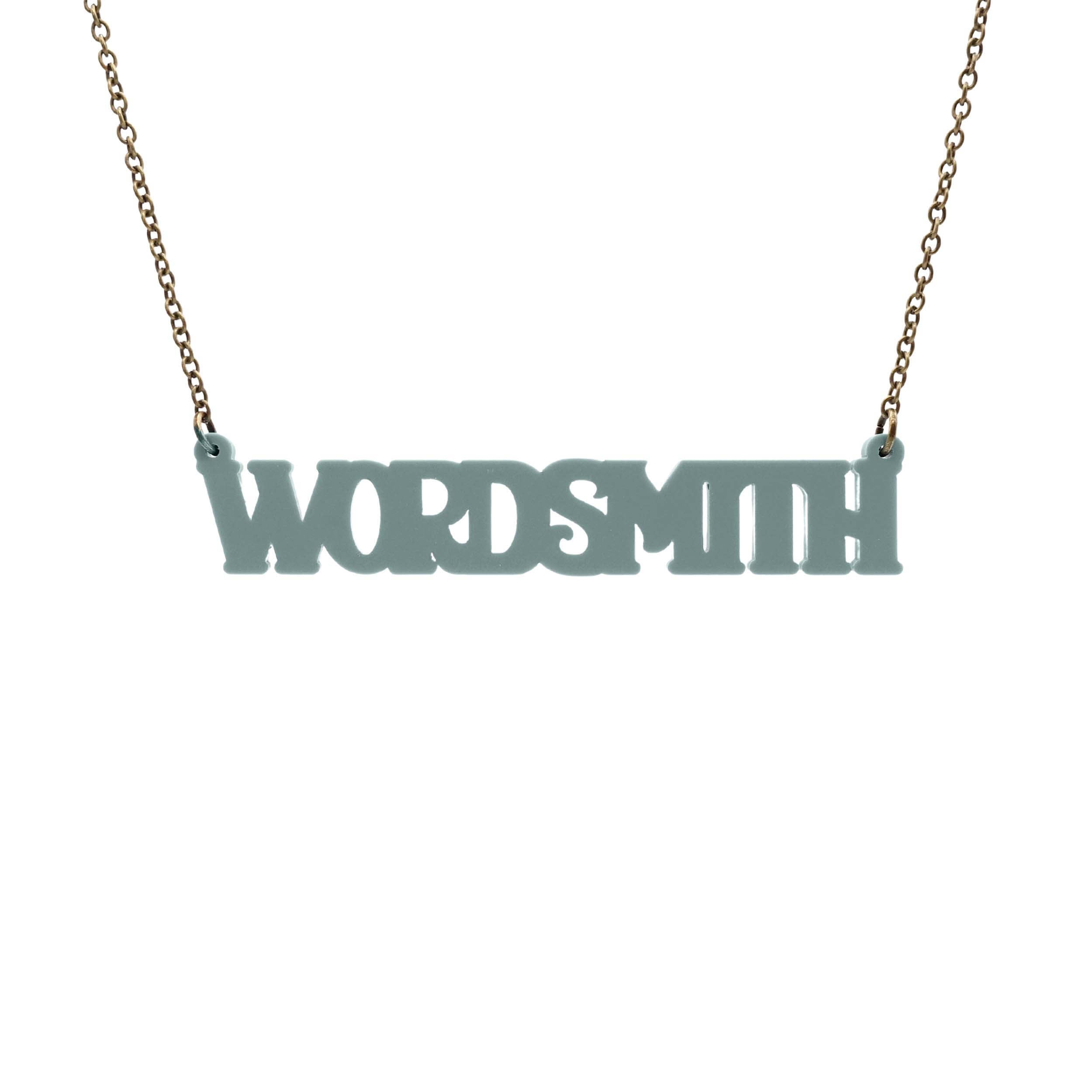 A necklace that says 'Wordsmith' in duck egg green, shown hanging against a white background.