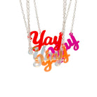 A group of Yay necklaces in all four colours shown hanging against a white background.
