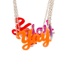 A group of Yay necklaces with fluoro orange in front shown hanging against a white background.