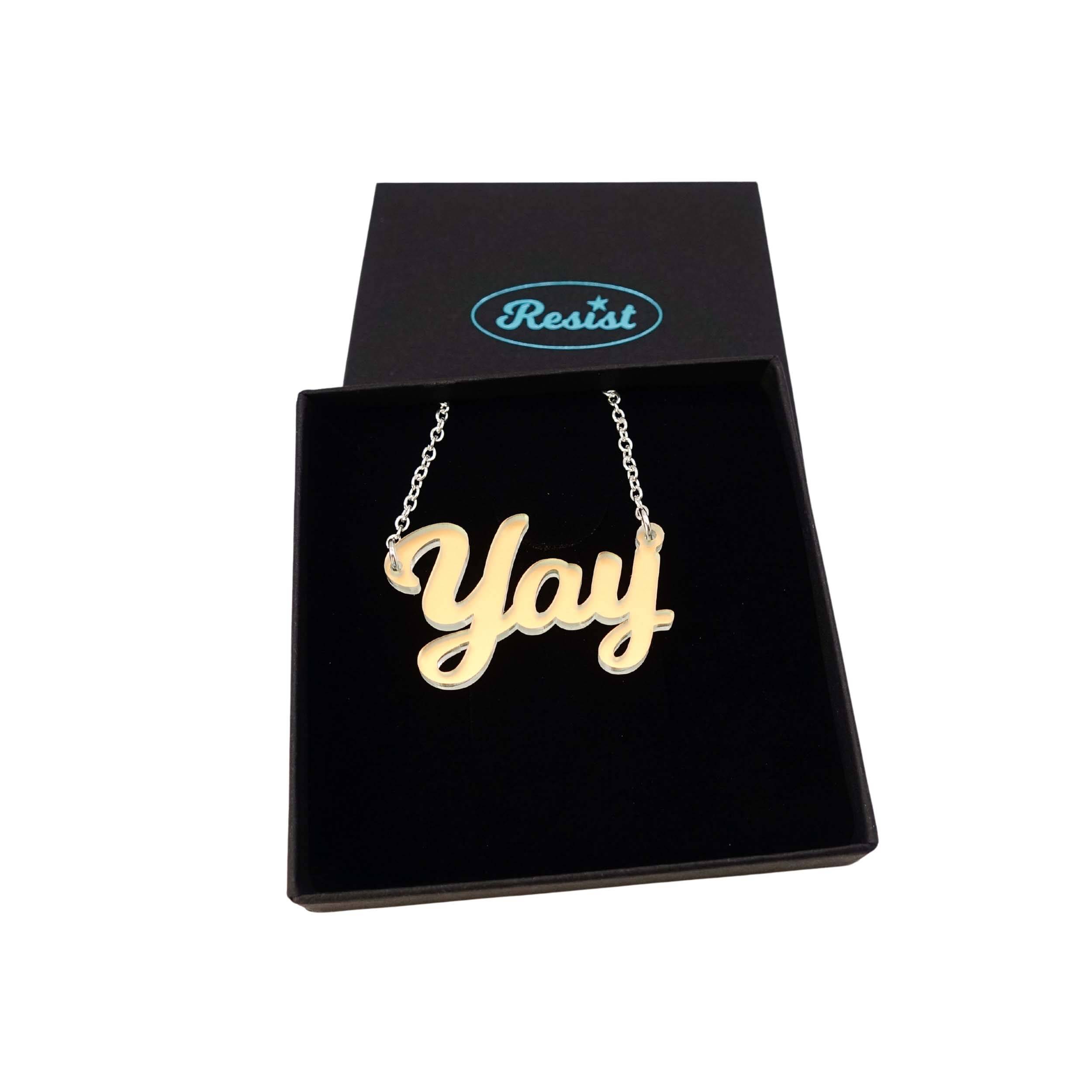 Yay necklace in matte iridescent shown in a Wear and Resist gift box.