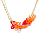 A group of Yee Ha necklaces shown hanging together with the fluoro orange in front.