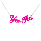 A neon pink Yee Ha necklace shown hanging against a white background.