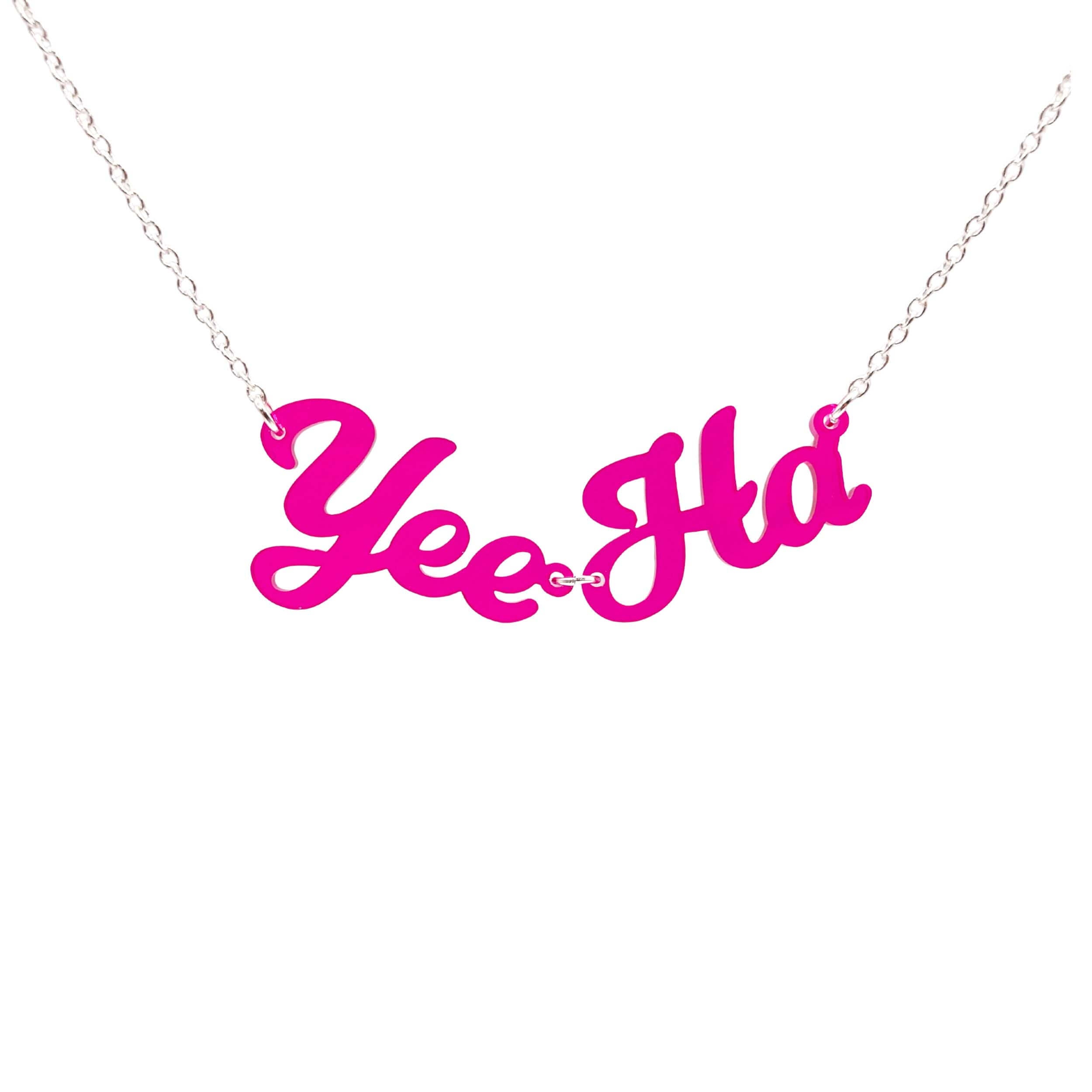 A neon pink Yee Ha necklace shown hanging against a white background.