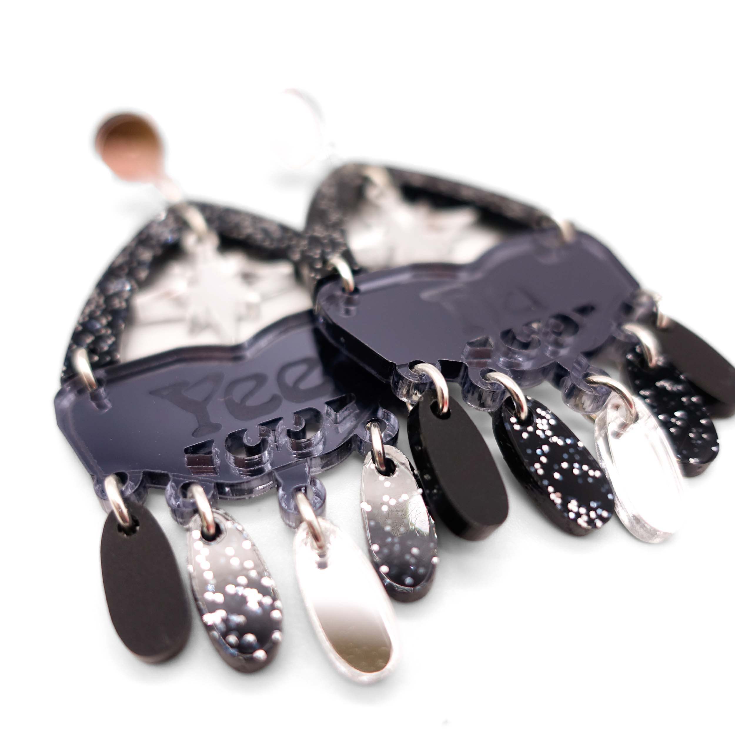 A close up of the Sky Midnight colourway of Western inspired Yee Ha earrings in slate mirror, matte black, black glitter and silver.