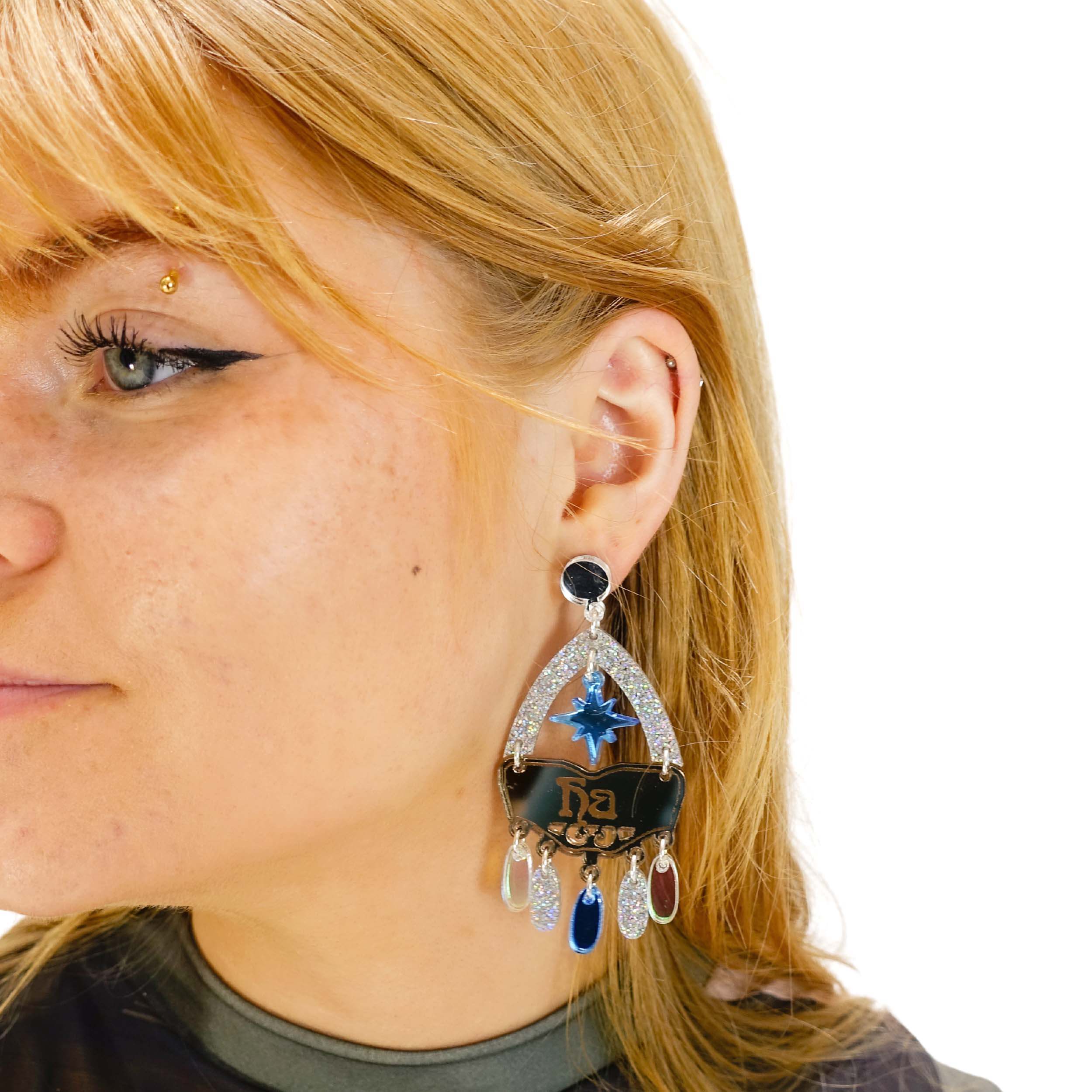 Eliza wears the Sky Cowgirl Yee Ha Western inspired statement earrings with sky blue stars.