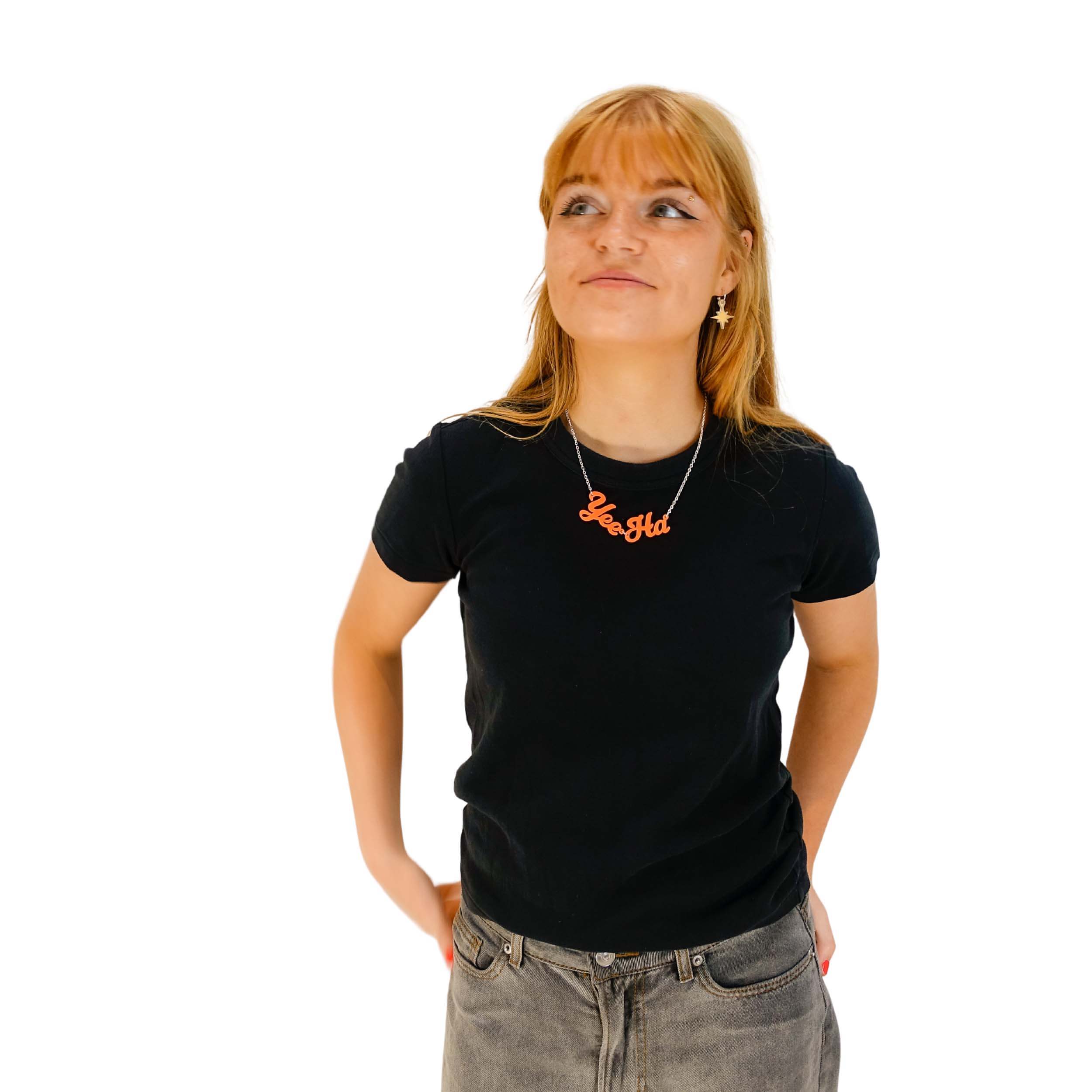 Eliza wears an orange Yee-Ha necklace.