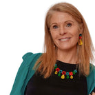 Sarah wears a Belle Epoque jewel necklace in flame mambo colours, and matching large Belle Époque Jewel drop earrings.  Brighten up on a budget!