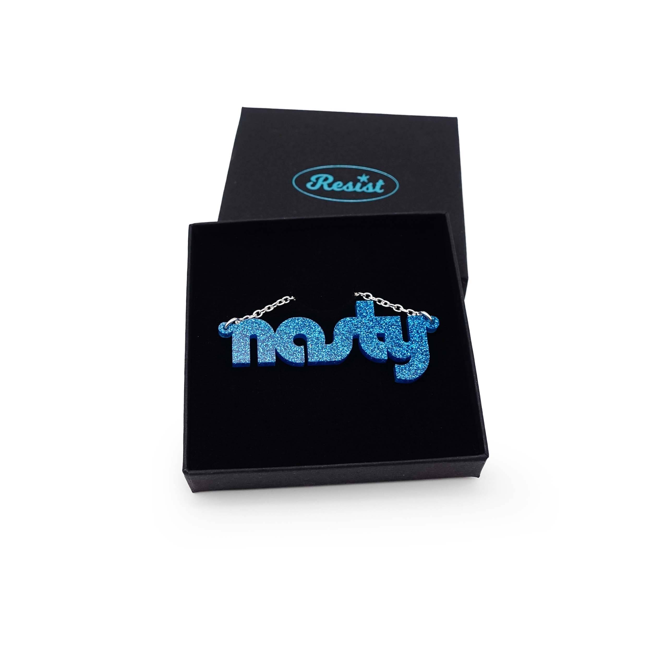 Nasty necklace in blue glitter, shown in a Wear and Resist gift box.