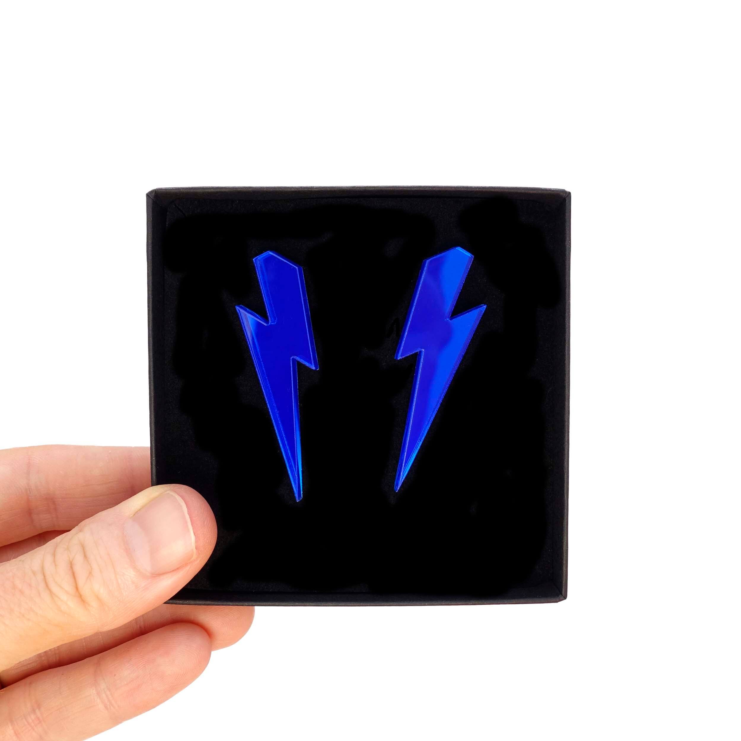 Large Lightning Bolt earrings in electric blue mirror, shown held up in a Wear and Resist gift box.