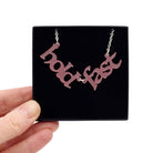 Hold Fast necklace in blush frost shown held up in a Wear and Resist gift box.