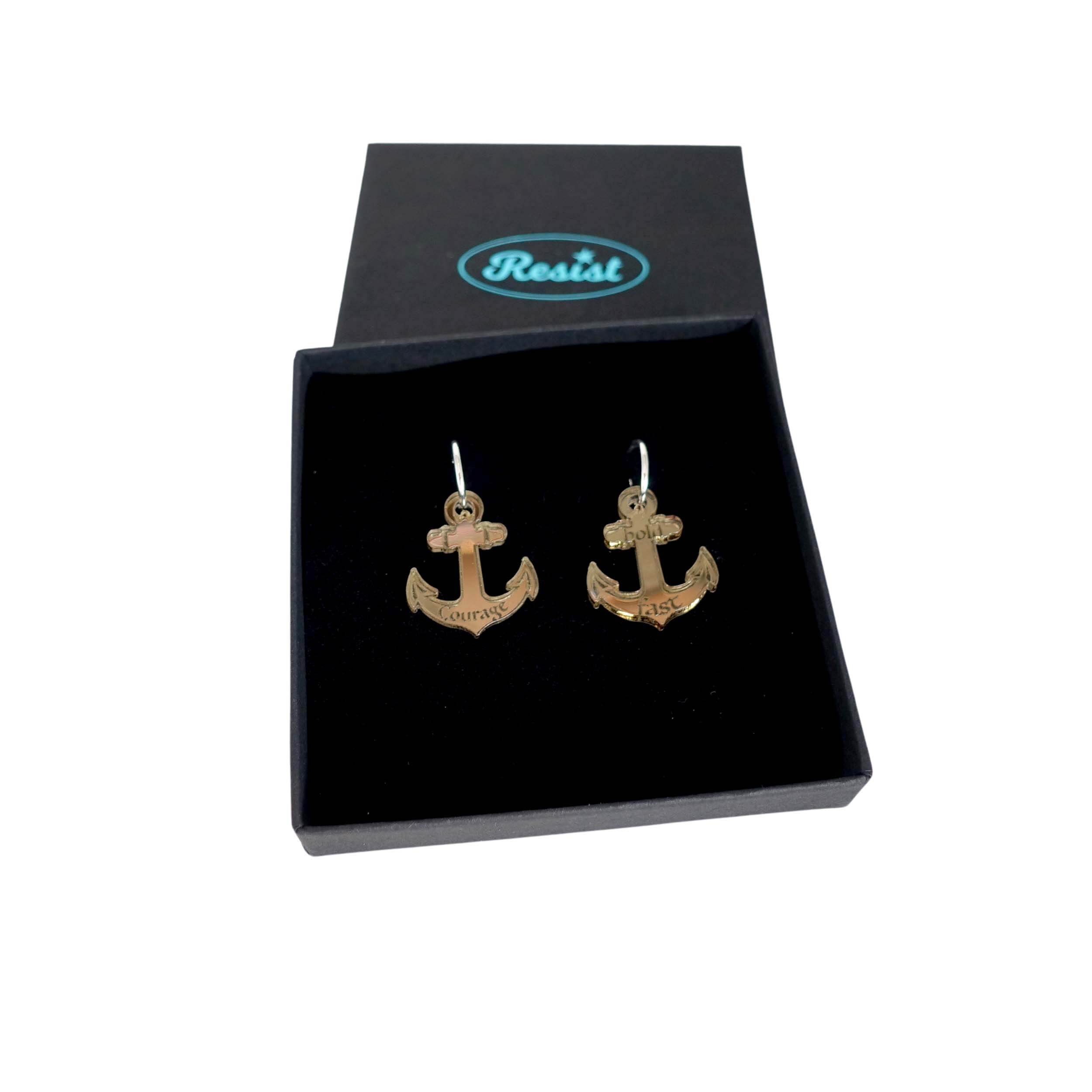 Medium anchor earrings in bronze mirror etched with the words 'courage' on one and 'hold fast' on the other. Shown in a Wear and Resist gift box.