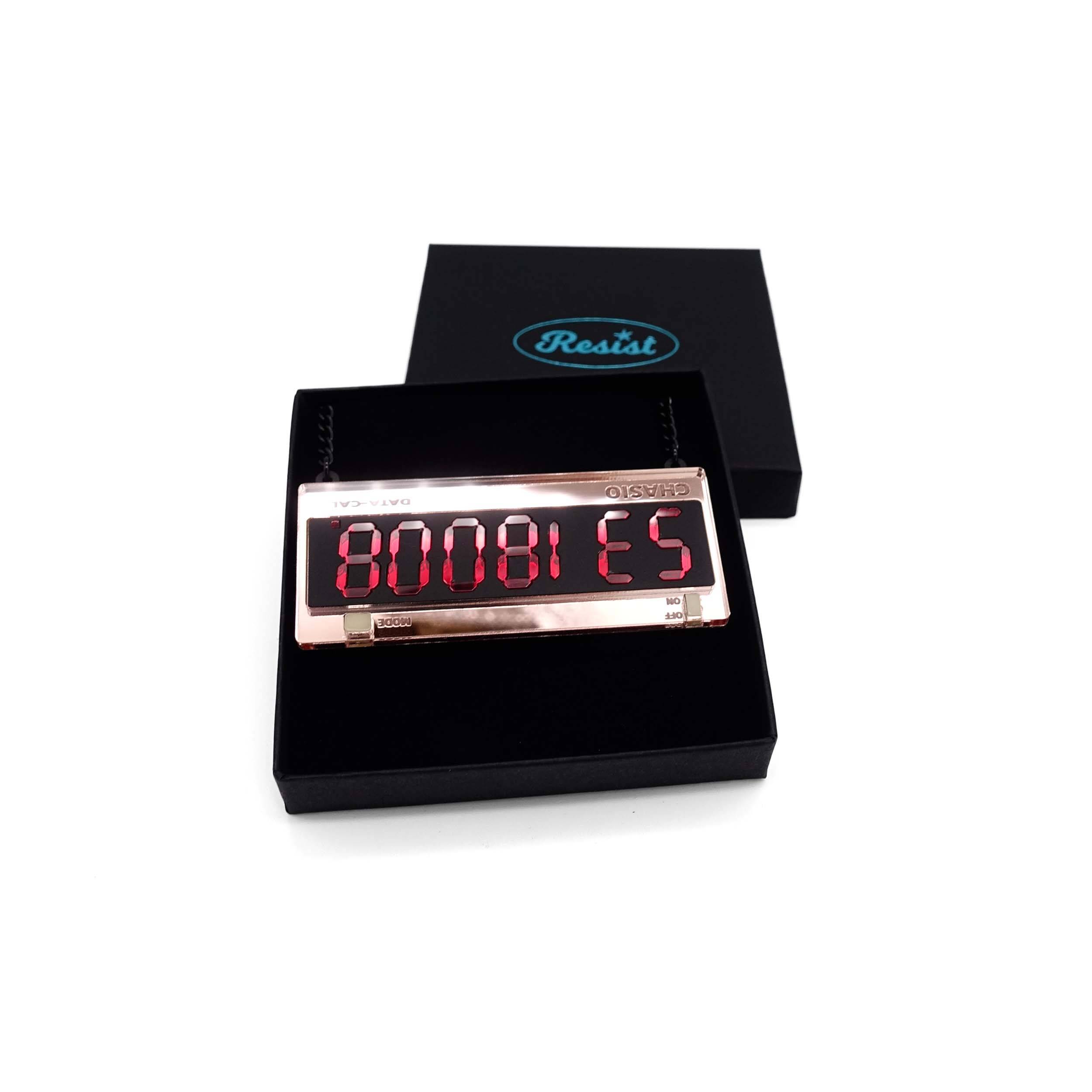 Calculator BOOBIES necklace shown in a Wear and Resist gift box.