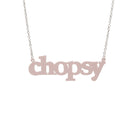 Chalk pink Chopsy necklace shown hanging against a white backround.