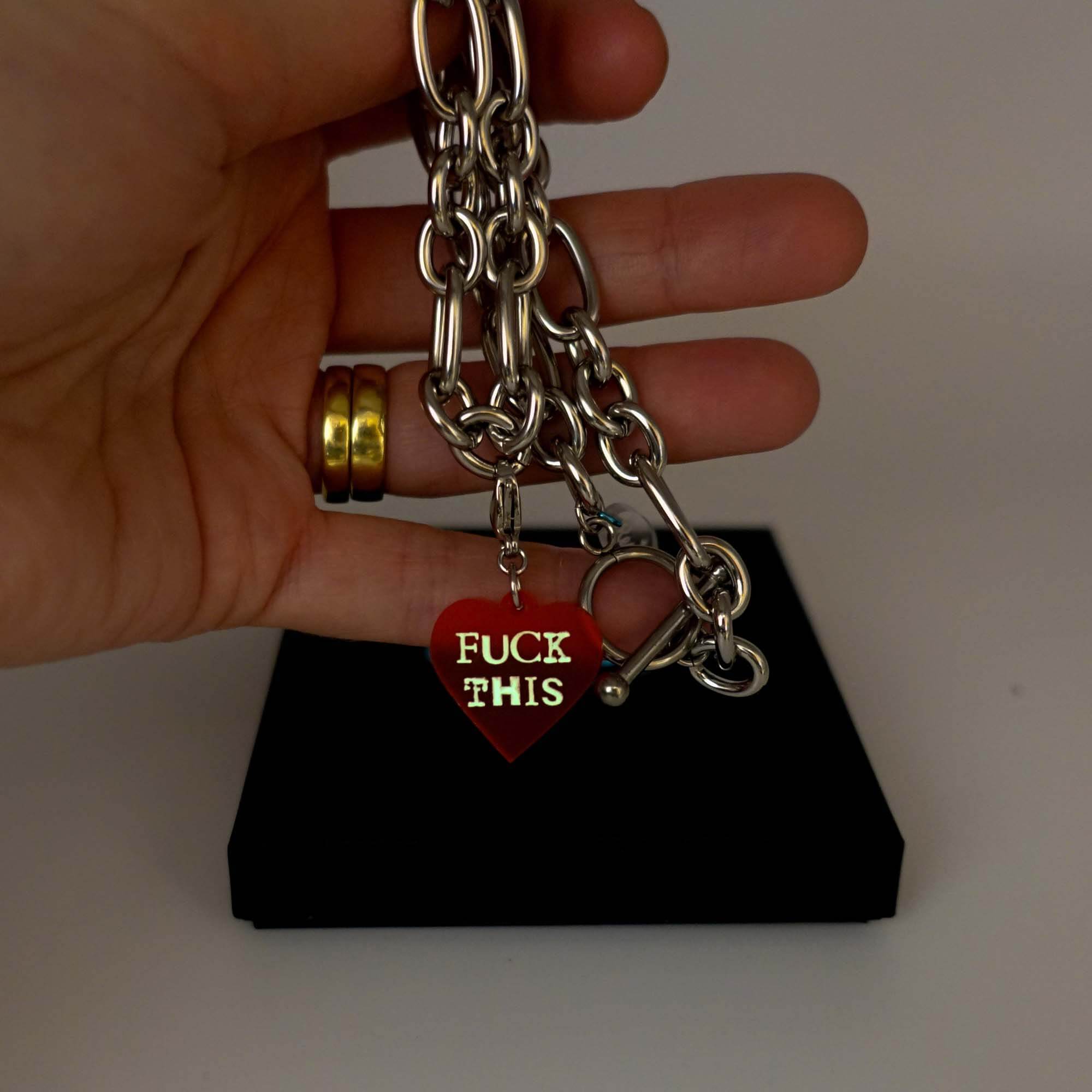 Stainless steel chunky chain charm necklace with a sweary charm glowing in the dark.