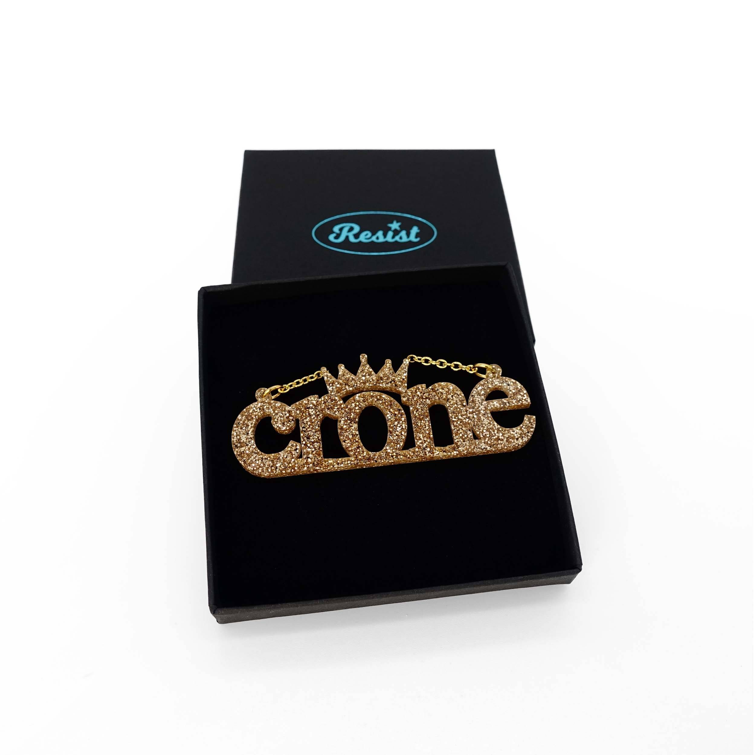 Crone necklace in gold glitter, shown in a Wear and Resist gift box.