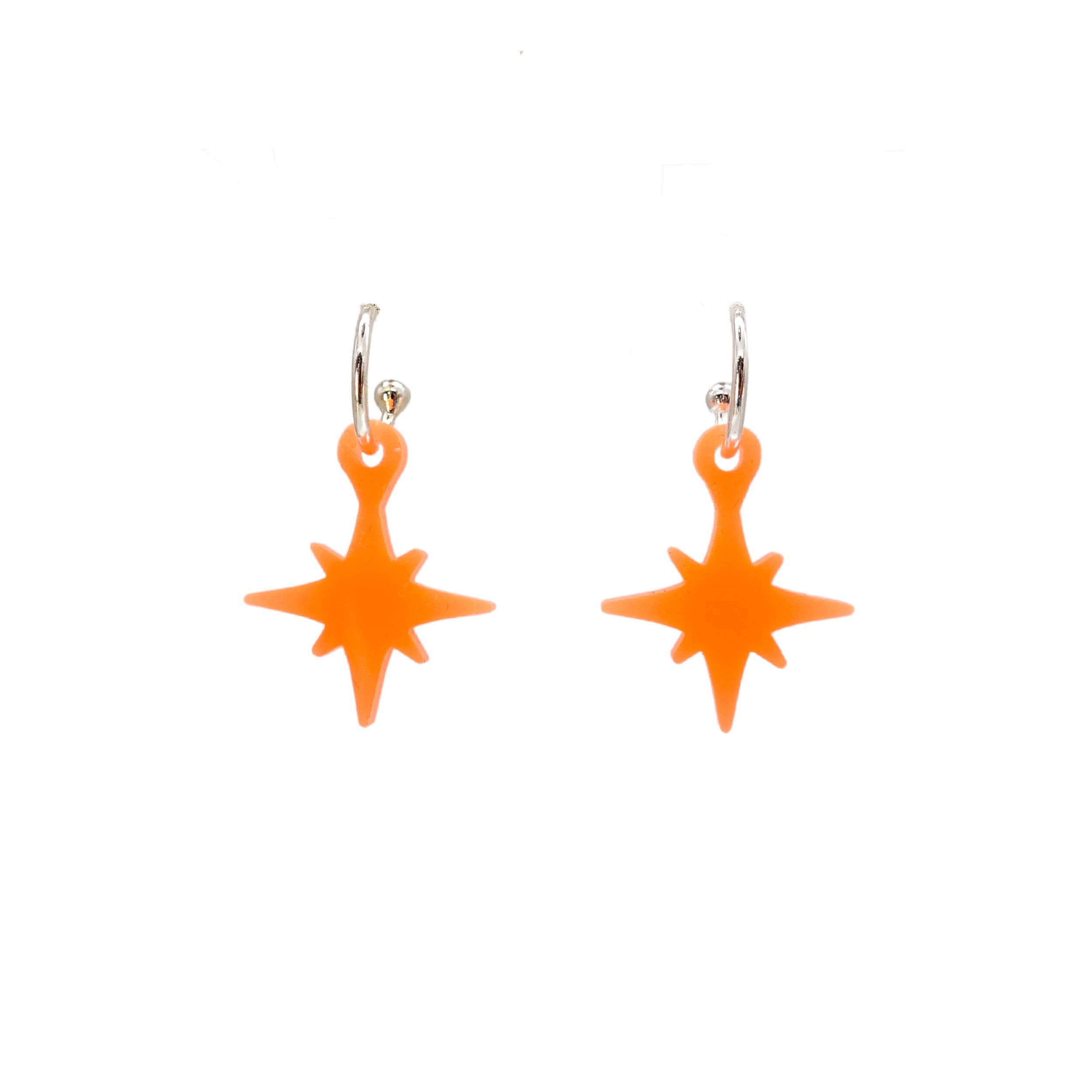 Neon vintage star earrings in fluoro orange shown on silver hoops against a white background.