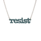 Duck egg green Resist necklace in typewriter font hanging on a silver chain against a white background.