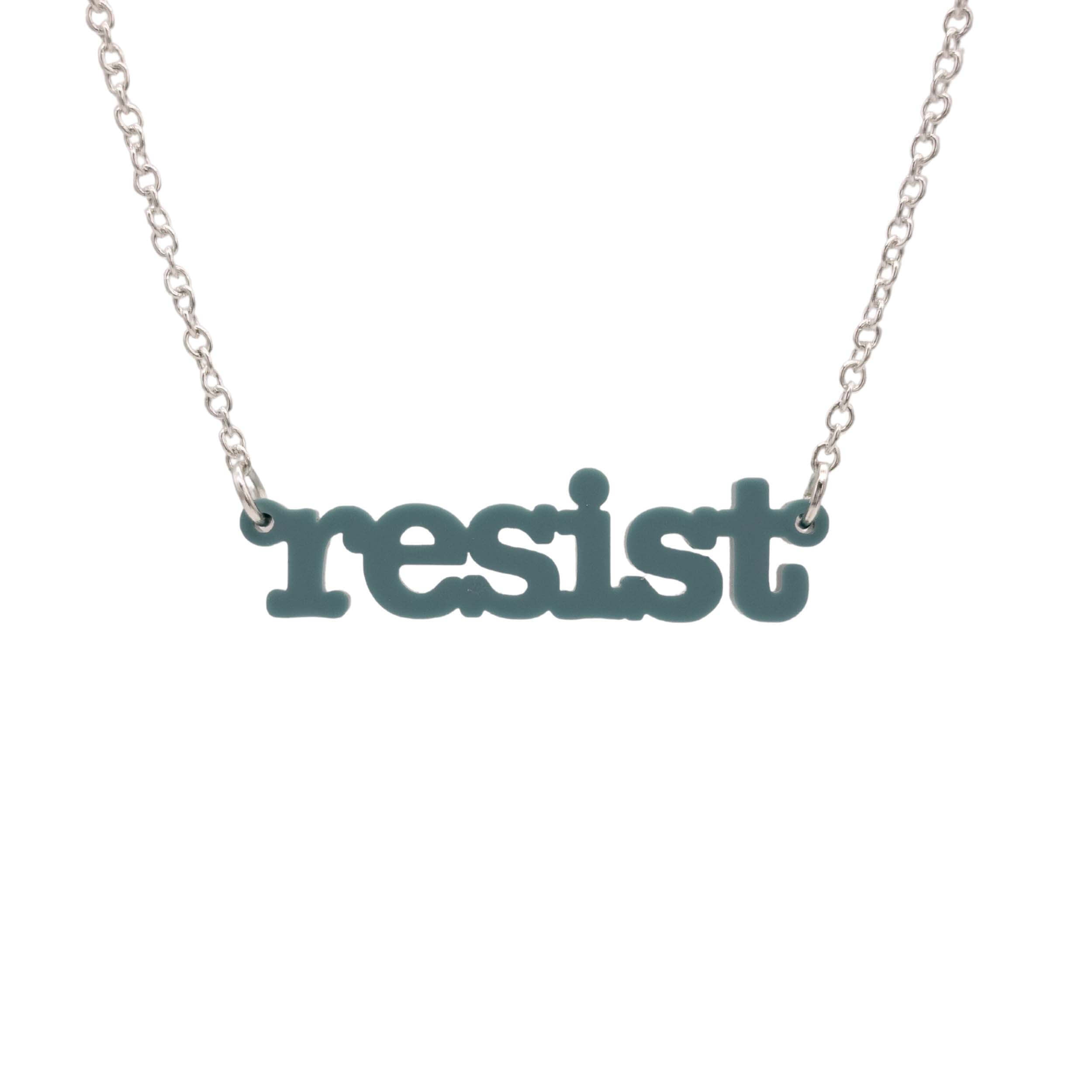 Duck egg green Resist necklace in typewriter font hanging on a silver chain against a white background.
