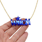 Witch necklace in electric blue mirror shown hanging against a white background with my hand for size.