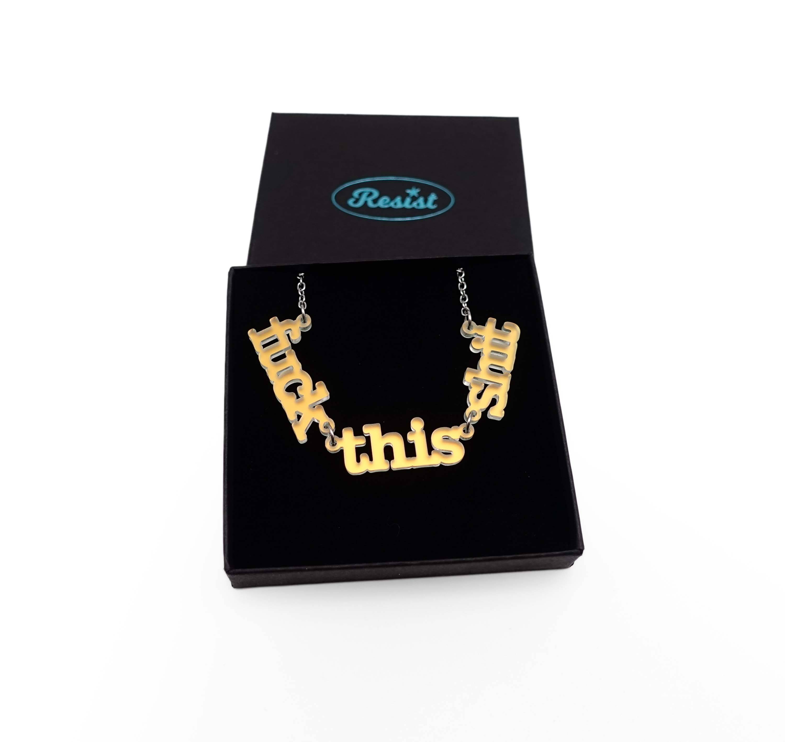 F*ck this Sh*t necklace in matte iridescent shown in a Wear and Resist gift box.