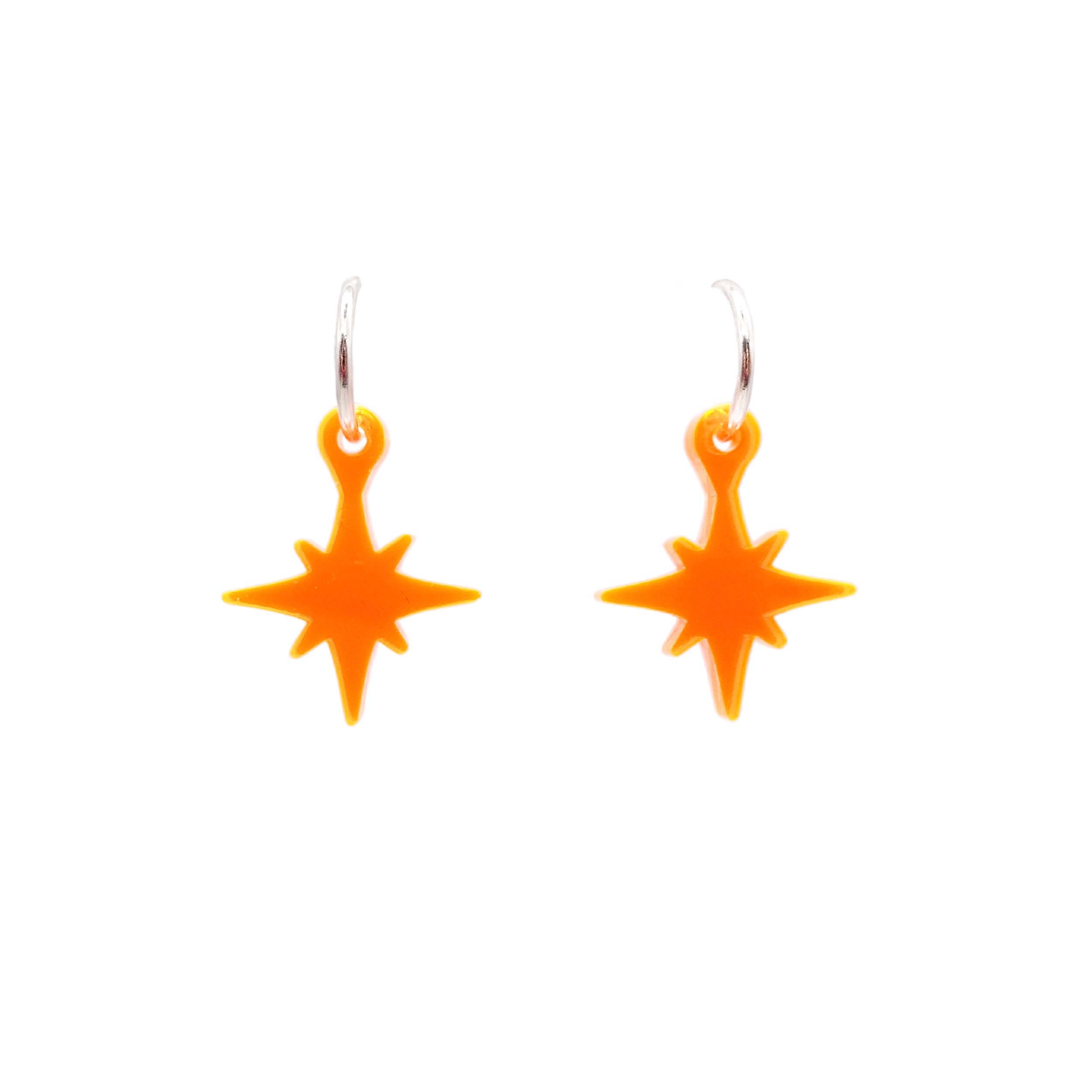 Neon vintage star earrings in clear orange shown on silver hoops against a white background.