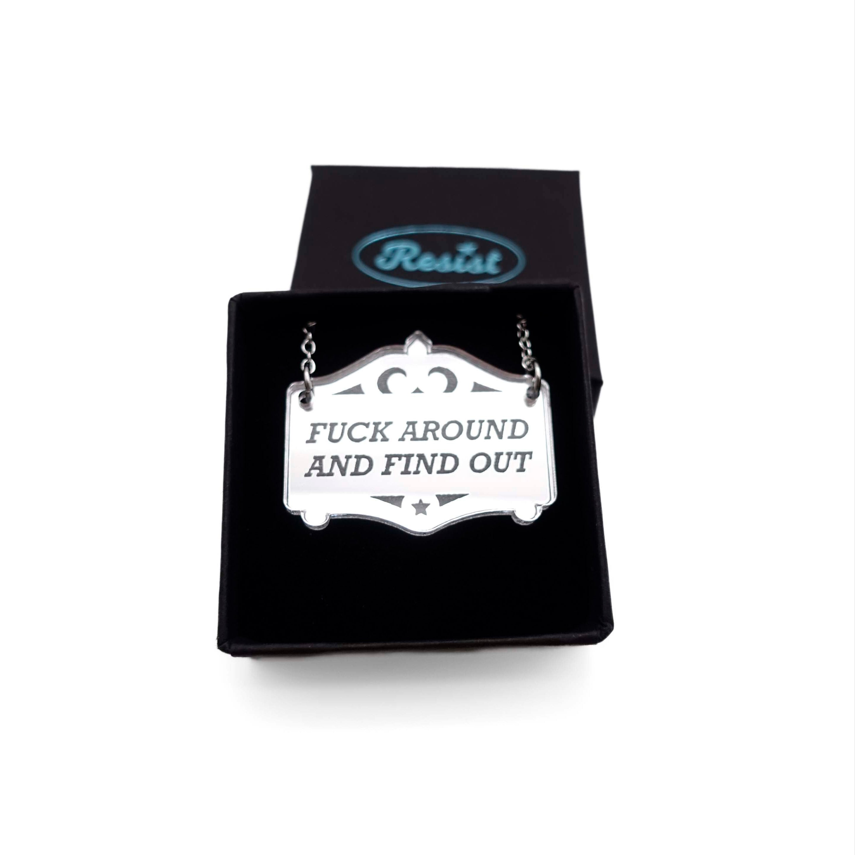 F*ck around and find out mirror cowboy necklace in silver, shown in a small Wear and Resist gift box.
